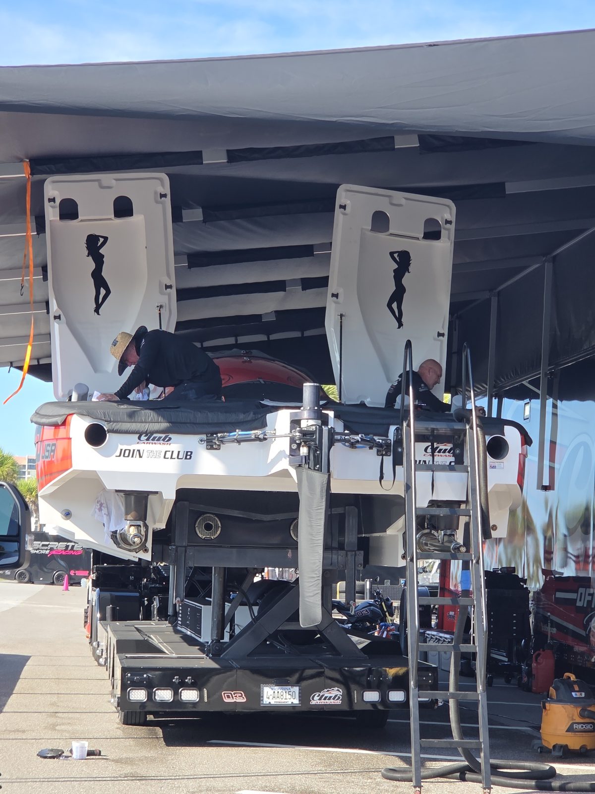 Outboards tilted up under the Club Car Wash awning
