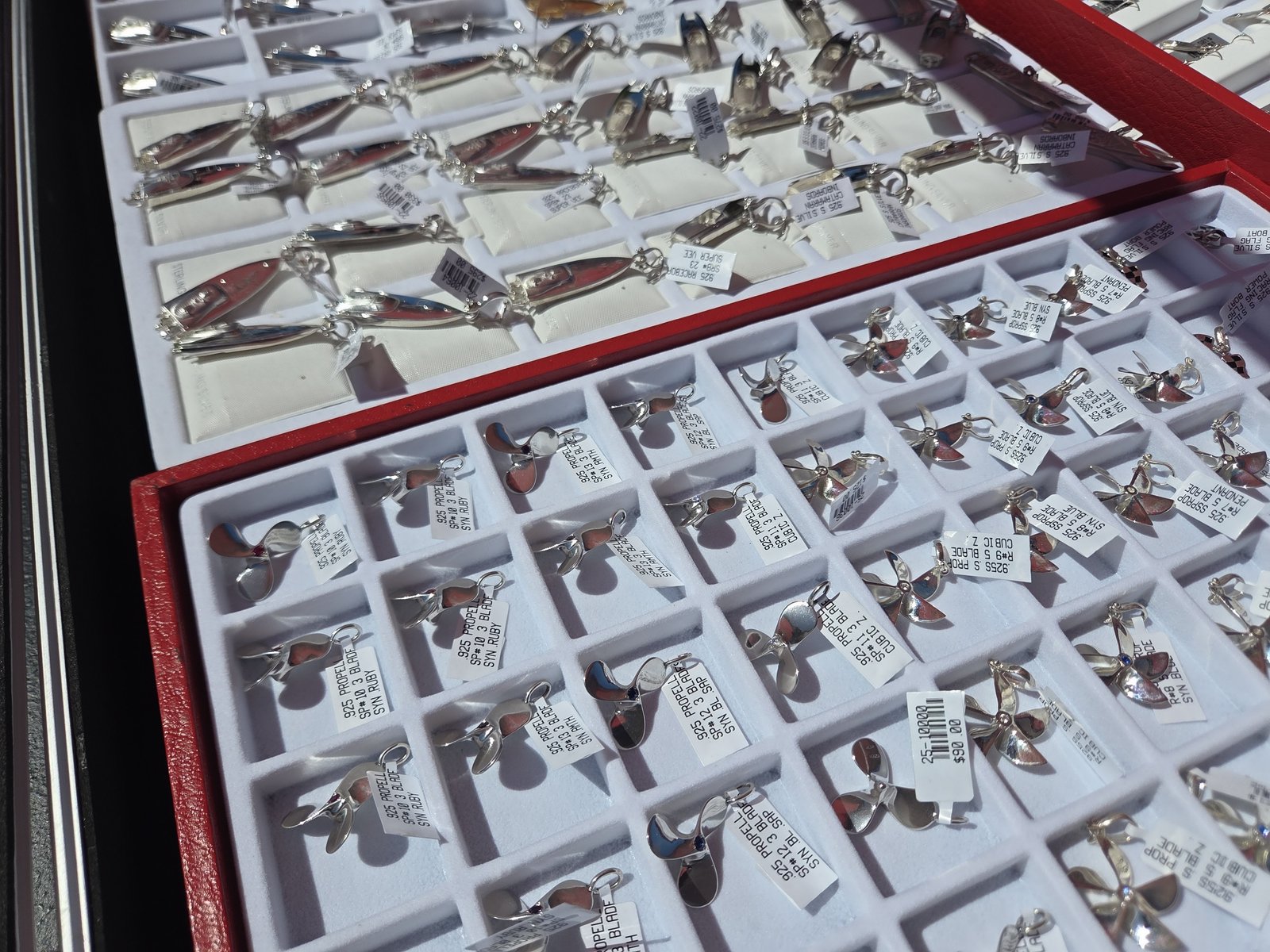 Tray of sterling silver propeller pendants