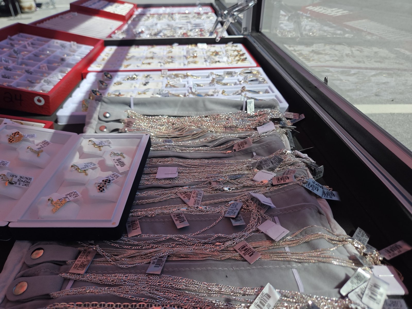 Display case of chains and pendants at the Robert Garcia Jewelry tent