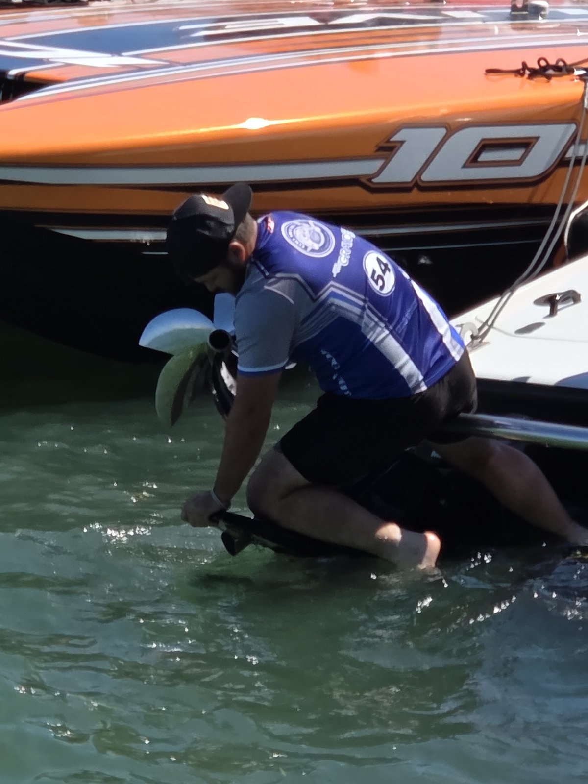 Close view of a crew member working the lower unit of boat number 10