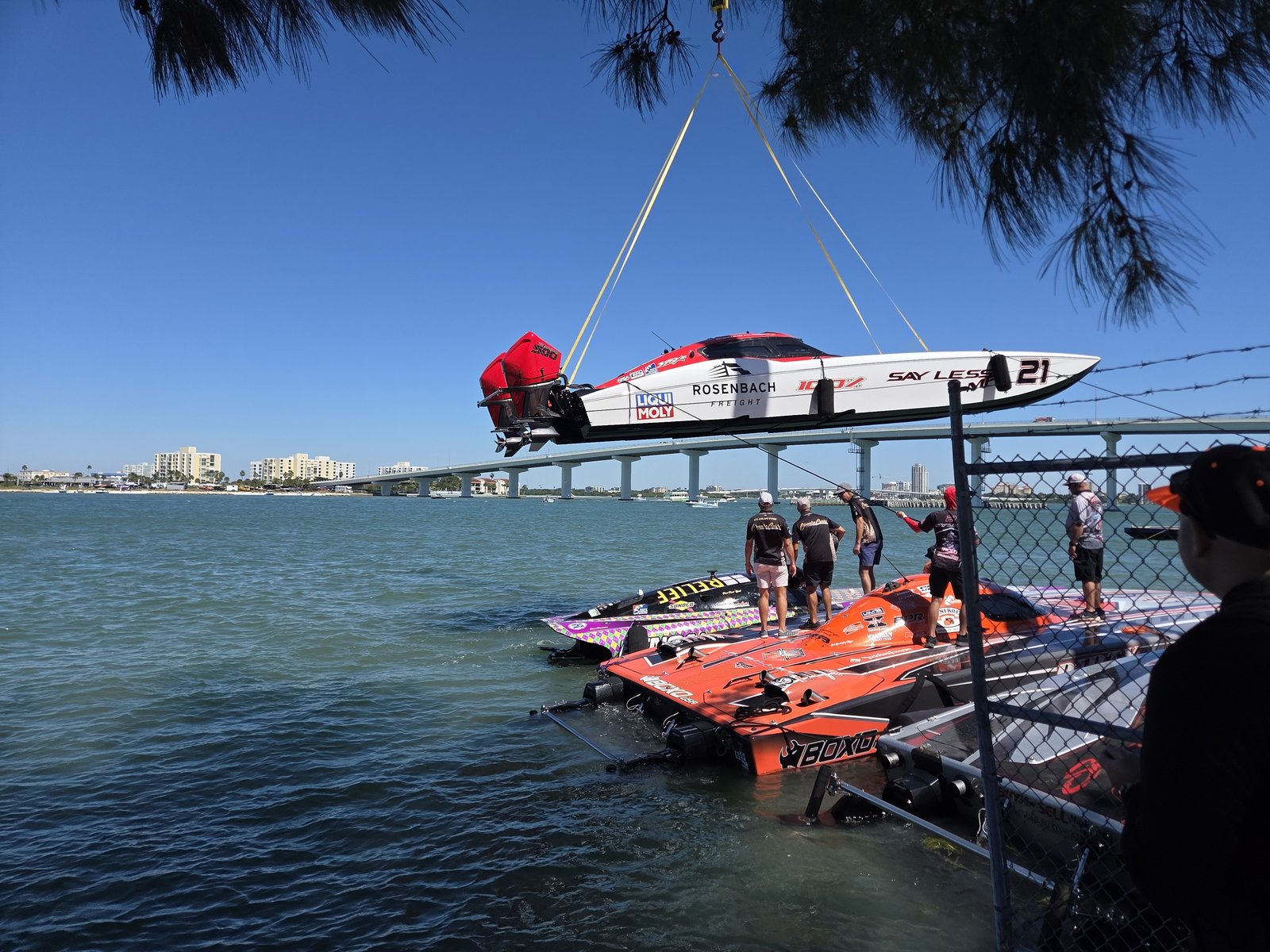 Race boat hanging from a crane during launch at Clearwater