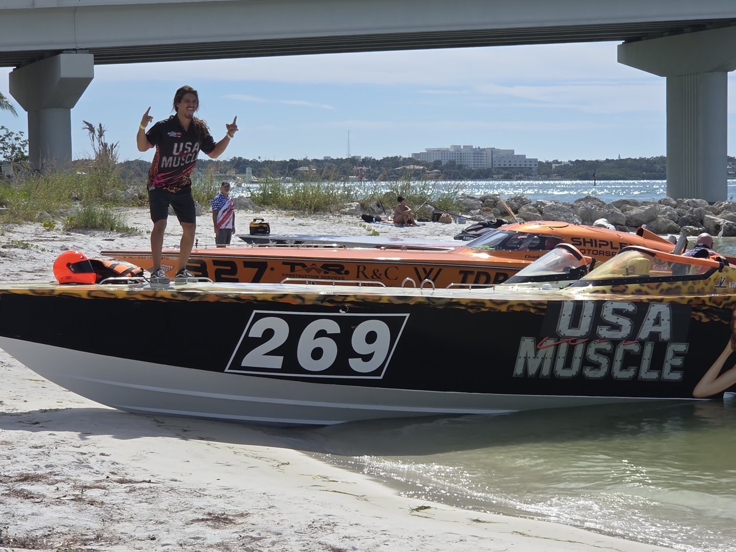 Crew member celebrating on the deck of race boat 269 USA Muscle