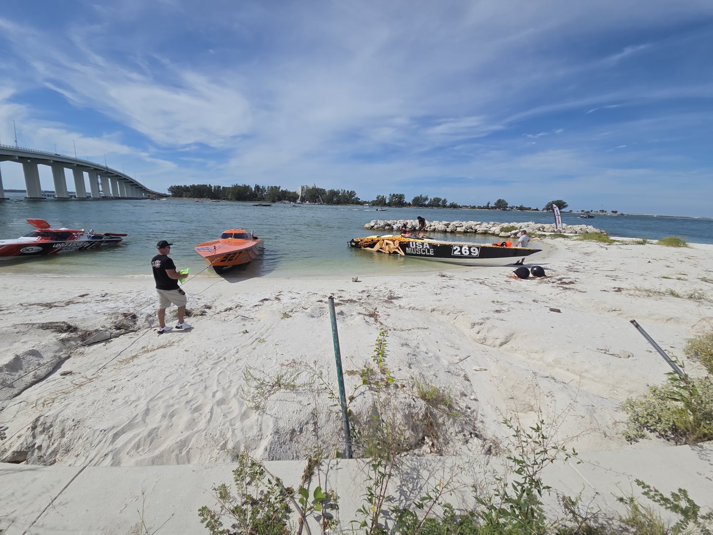 Race boats pulled up on the beach near the Clearwater bridge