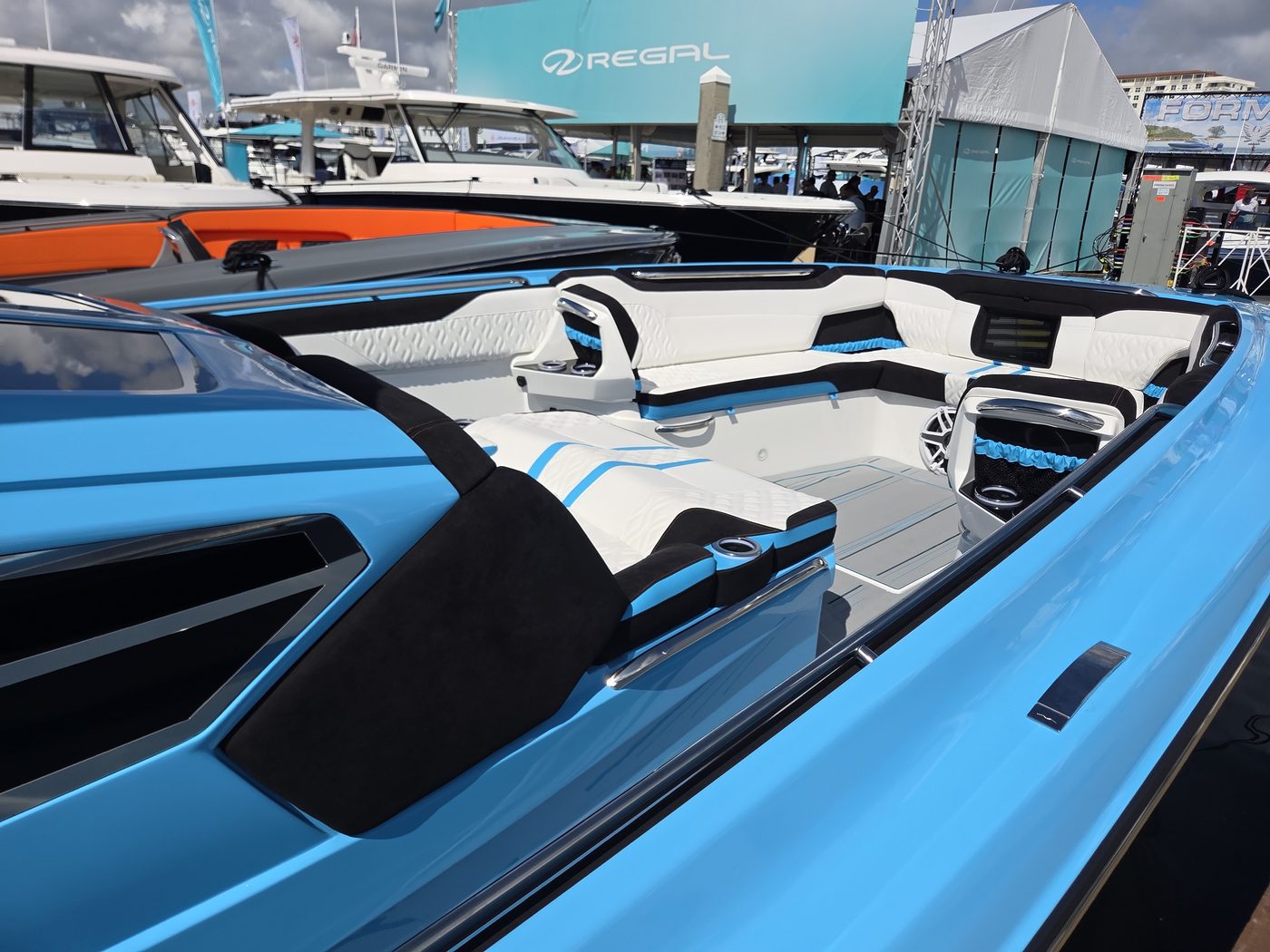 Baby blue sport boat with white upholstery at FLIBS 2026