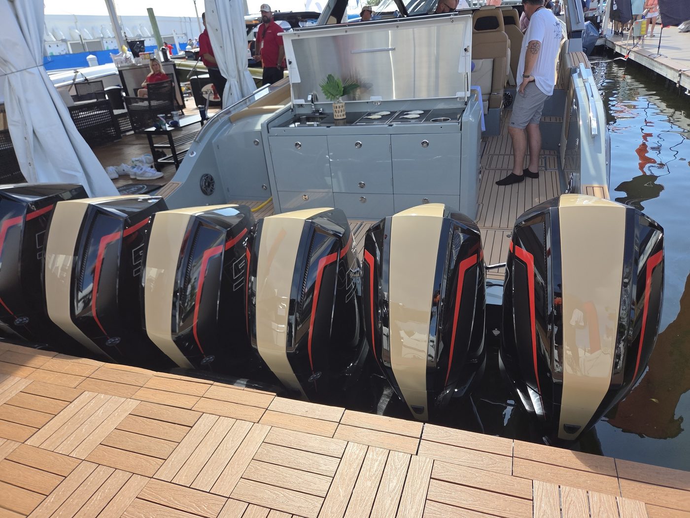 Row of six black, gold and red outboard cowls on a Cigarette