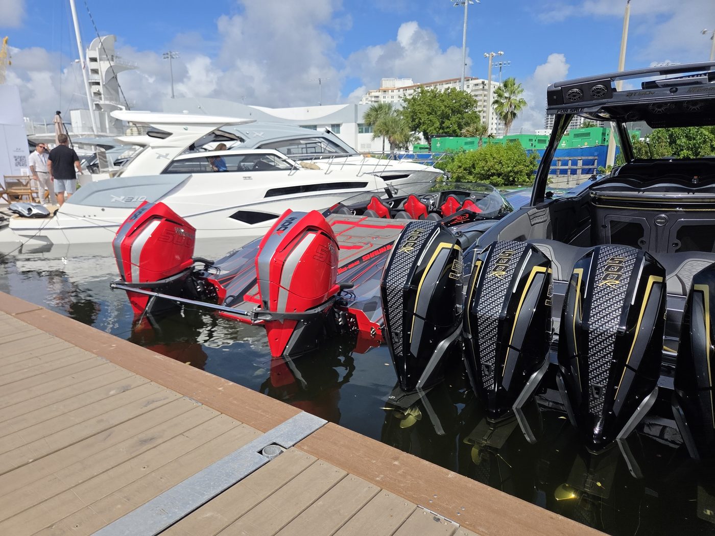 Red and black carbon-pattern outboards on performance boats at FLIBS 2026