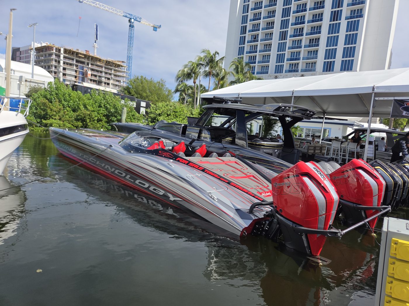 Red and silver performance catamaran with twin red outboards