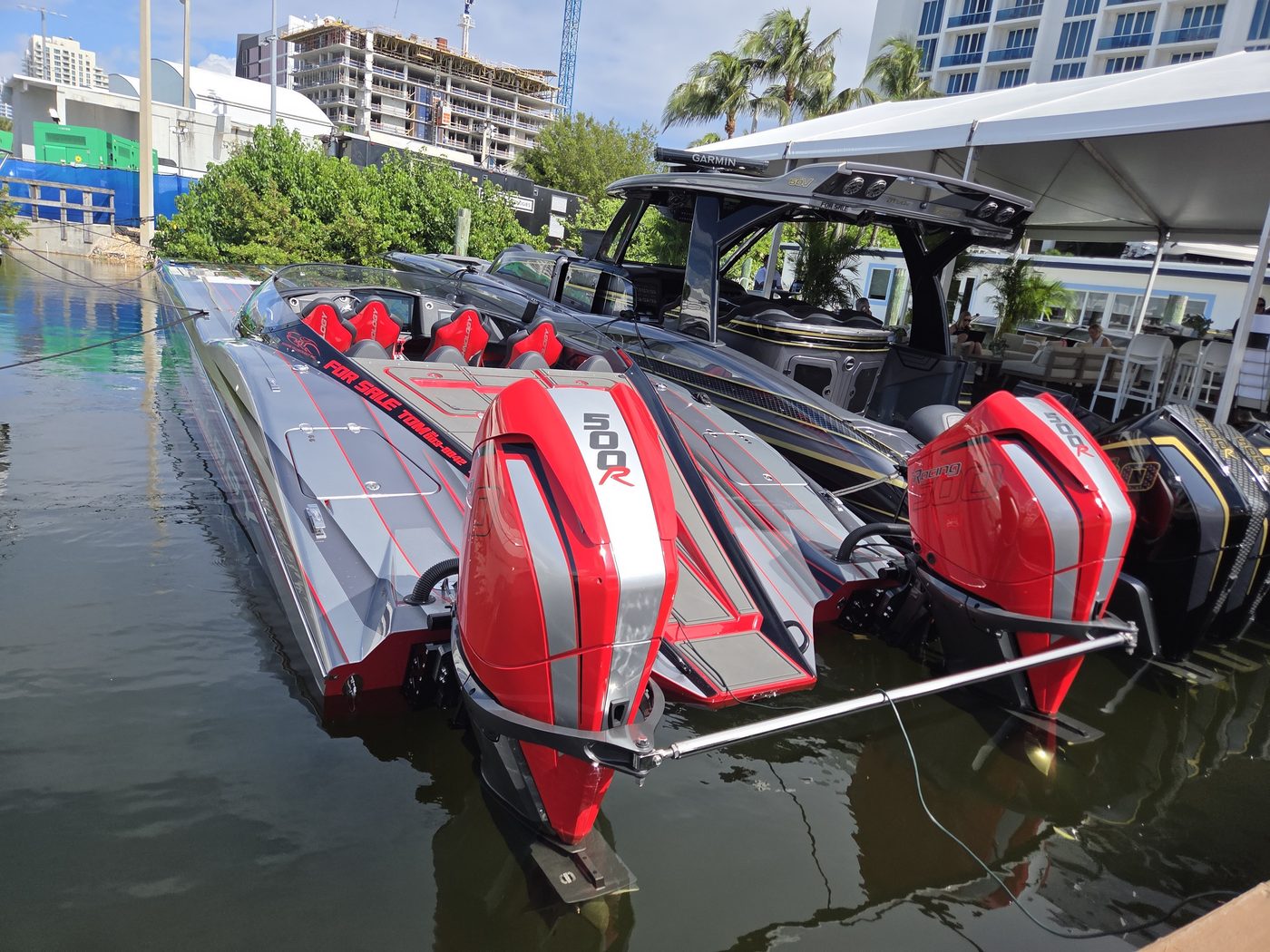 Red performance boat with twin red outboards in the water