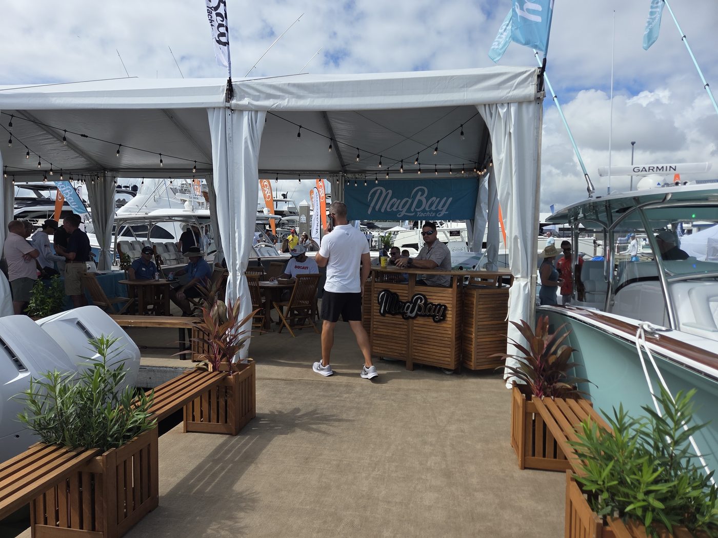 Dockside lounge tent with wooden bar at FLIBS 2026