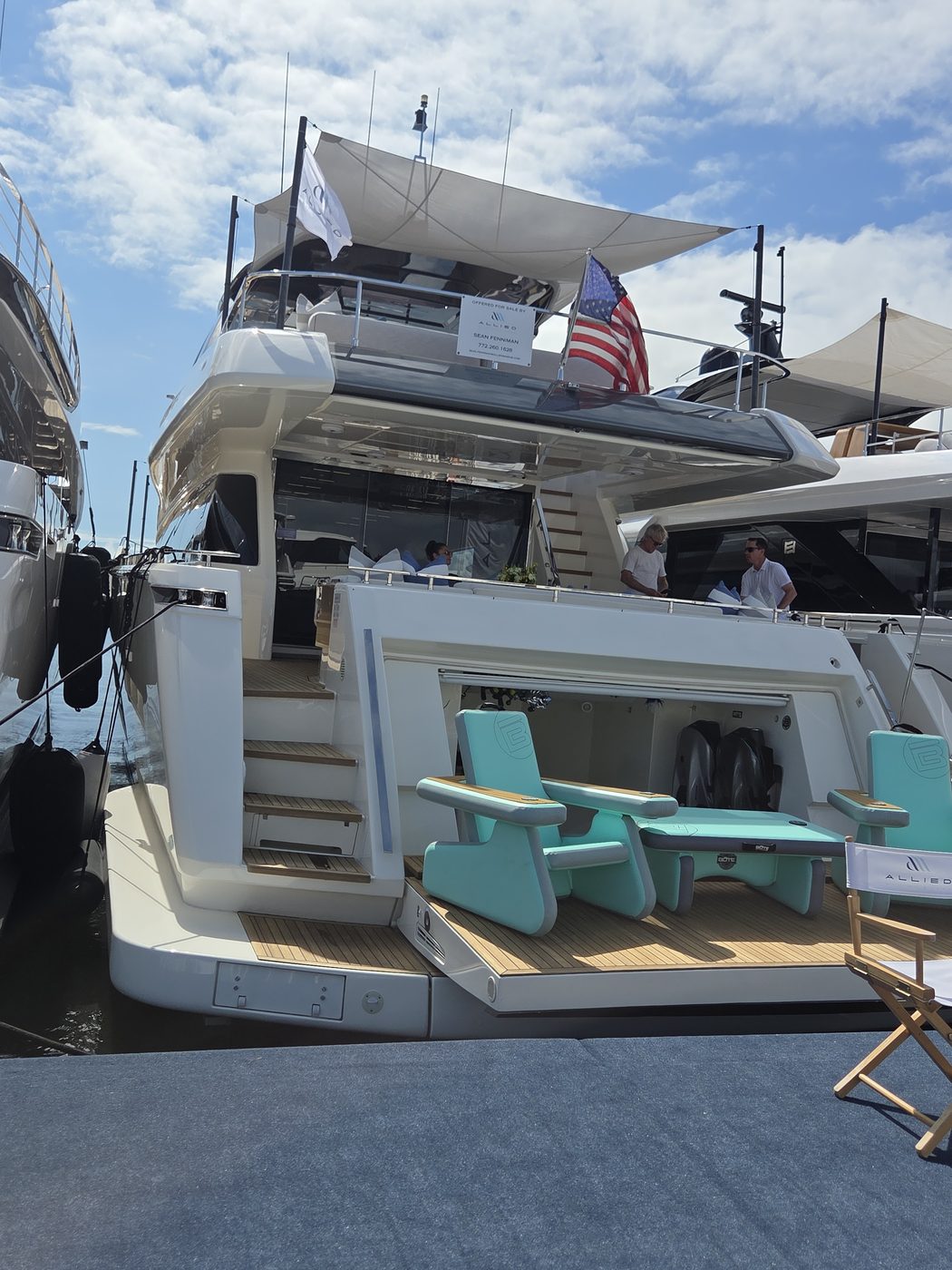Motor yacht aft deck with teal chairs