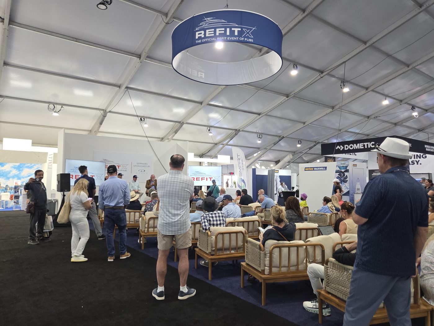 RefitX lounge with seating in the exhibit tent