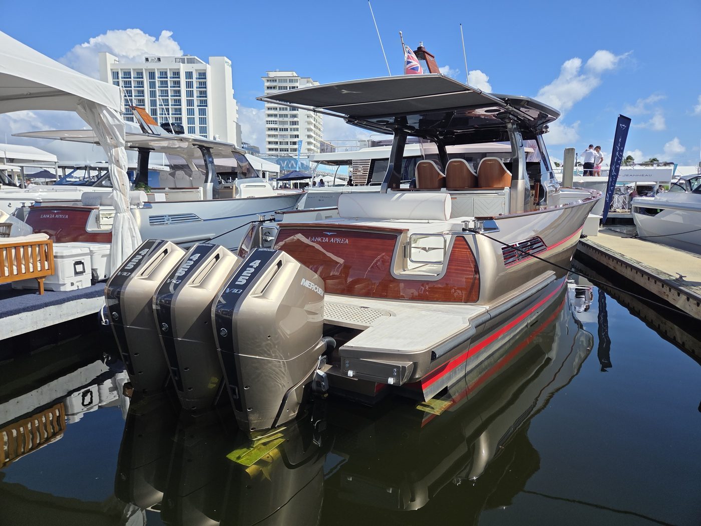 Dayboat with triple bronze outboards and red interior at FLIBS 2026