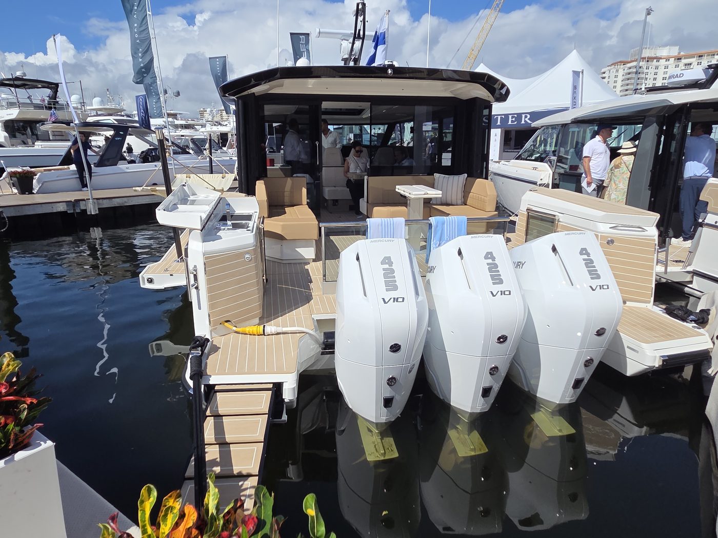 Hardtop dayboat with triple white outboards at FLIBS 2026