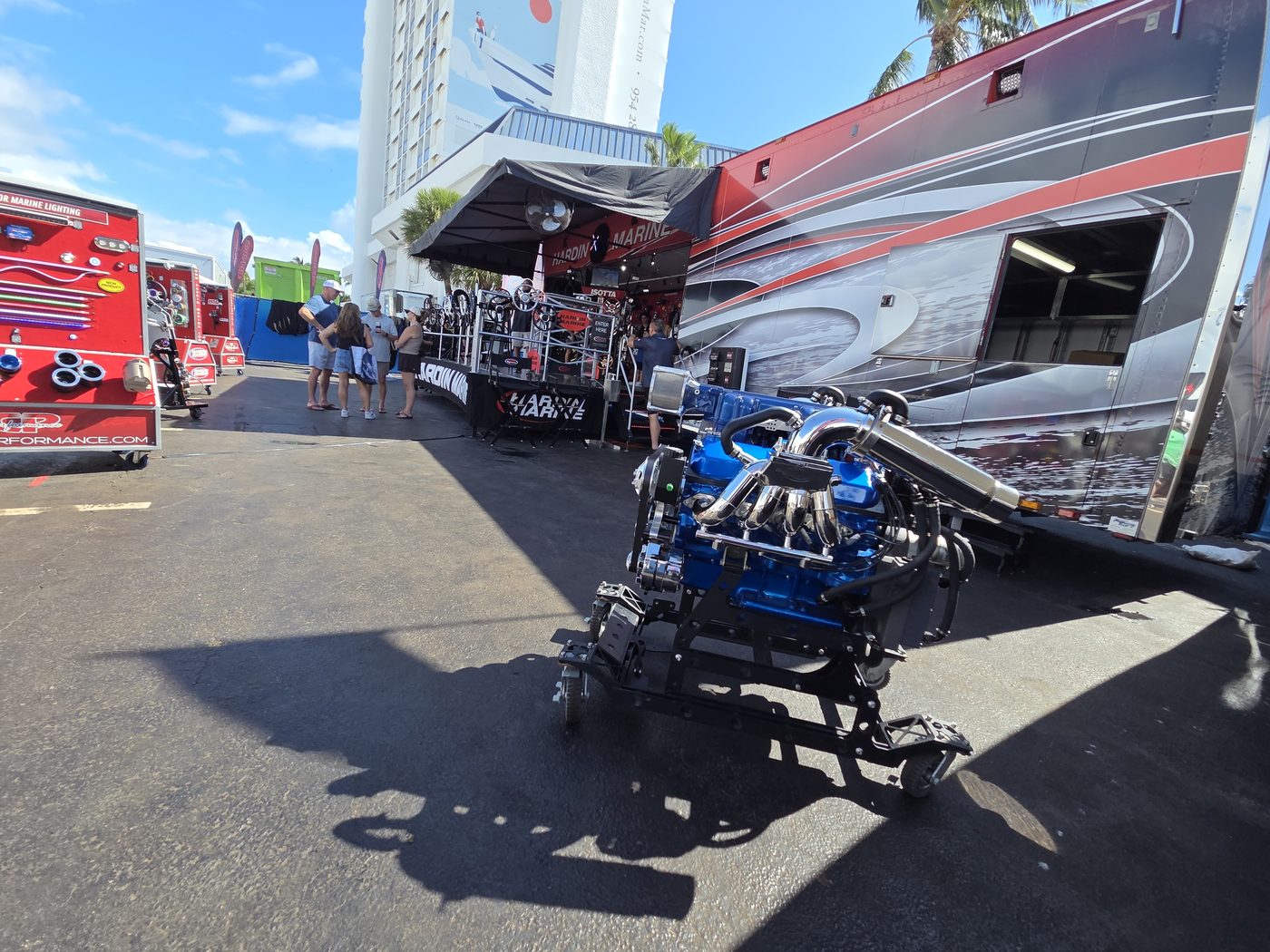 Blue race engine on a stand beside a race rig at FLIBS 2026