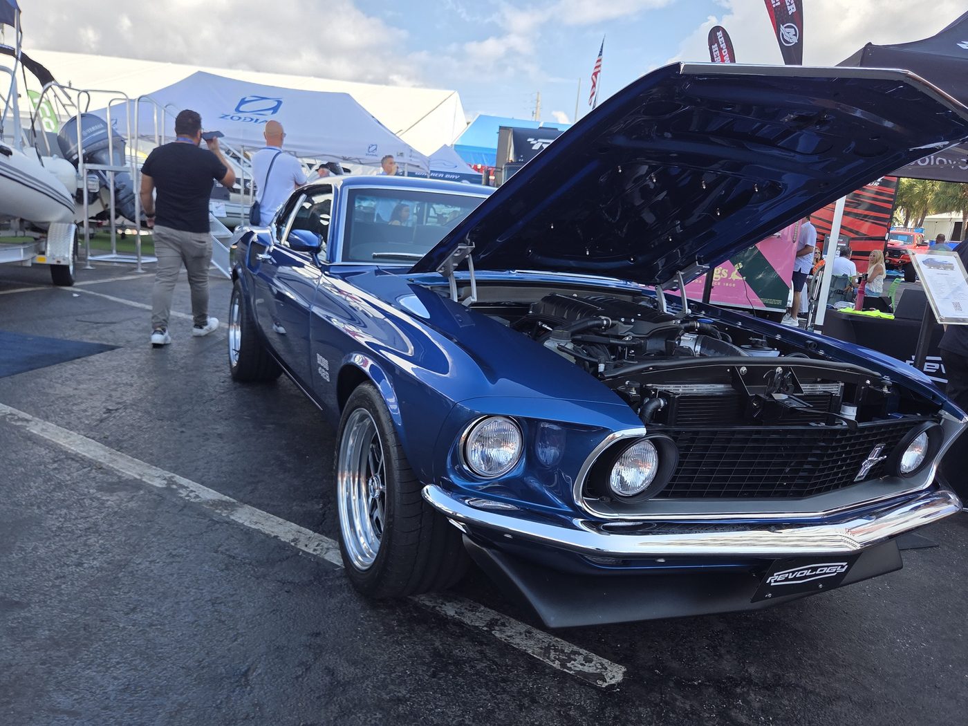 Blue classic Mustang with the hood up at FLIBS 2026