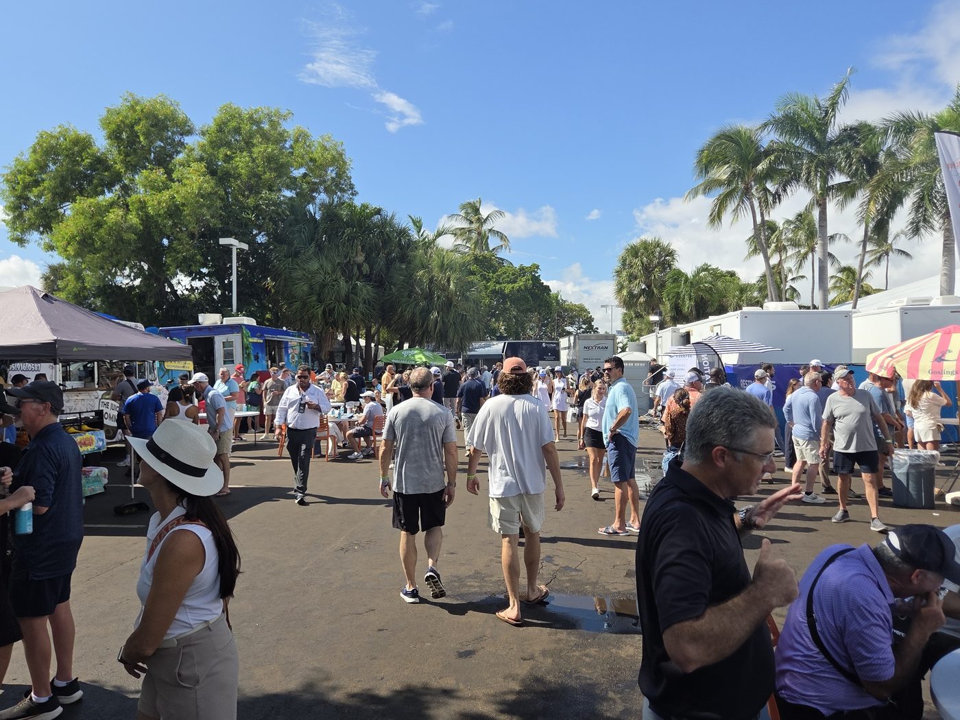 Crowds walking the FLIBS 2026 grounds under palm trees