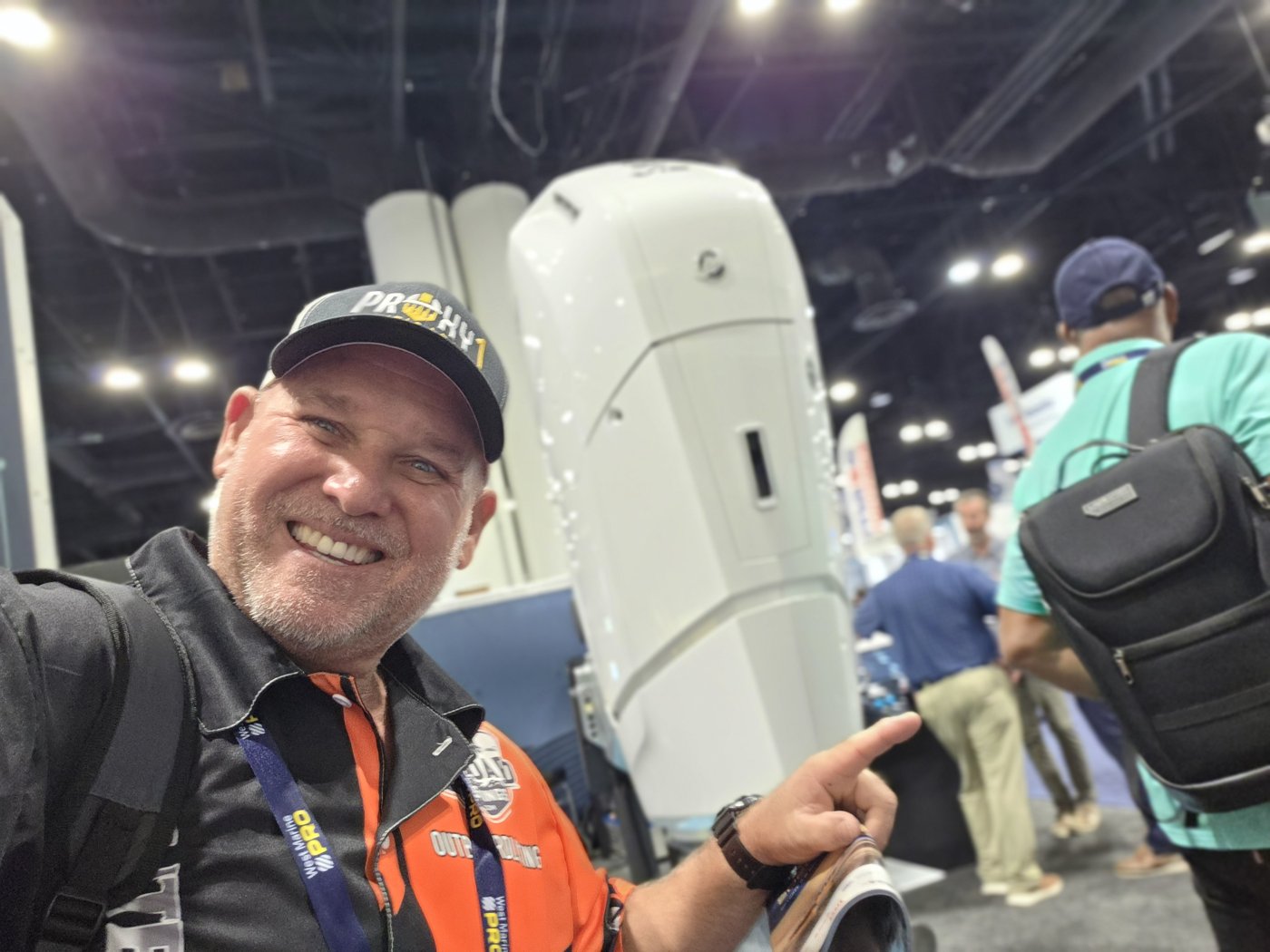OutboardListings founder with a white outboard motor at IBEX 2026