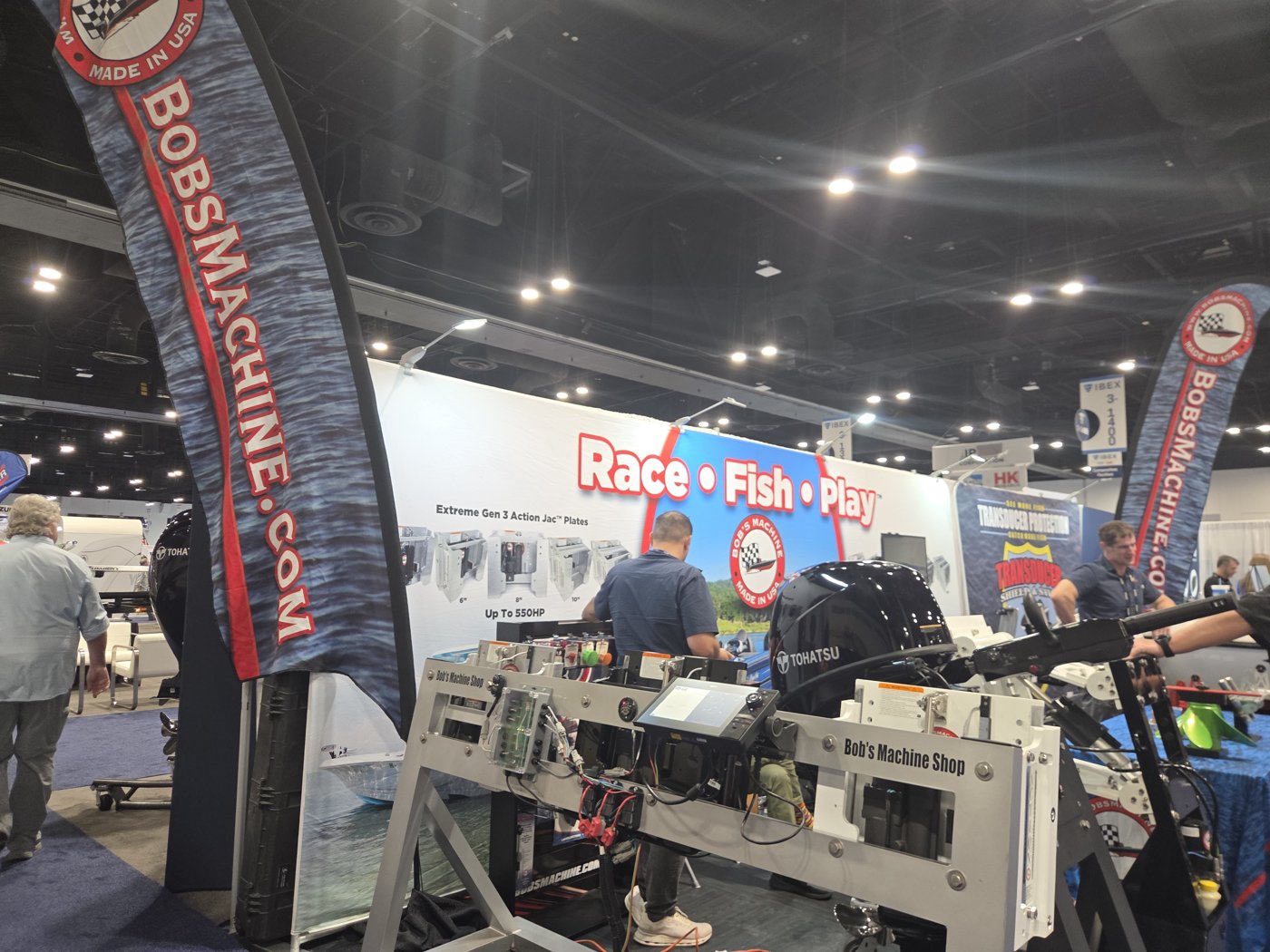 Bobs Machine Shop booth with jack plates and a Tohatsu outboard, Race Fish Play