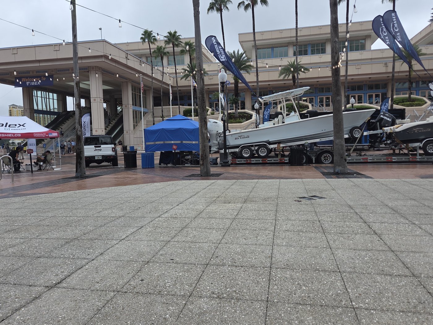Welcome to IBEX banner outside the Tampa Convention Center with a Sea Chaser center console on a trailer