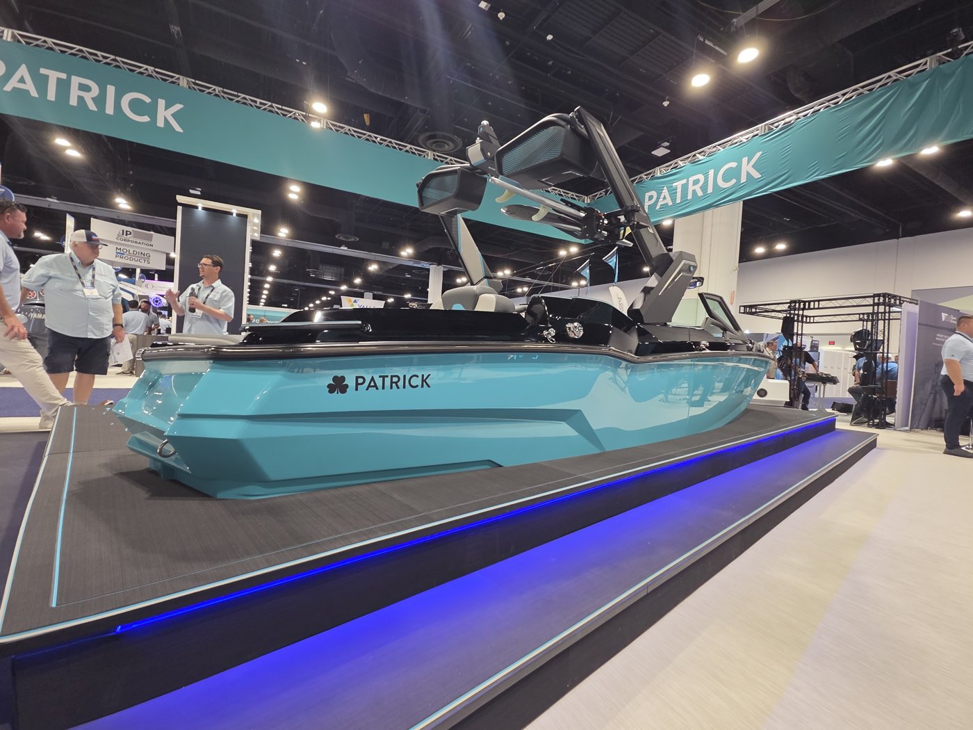 Side view of the teal Patrick concept wake boat with tower speakers