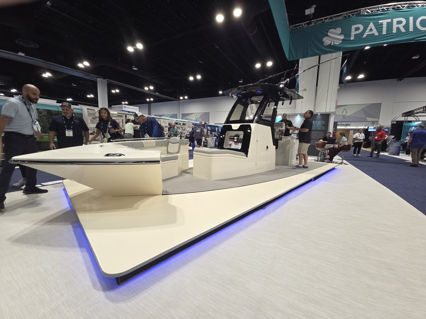 Patrick cream center console concept boat with black T-top on a blue LED platform