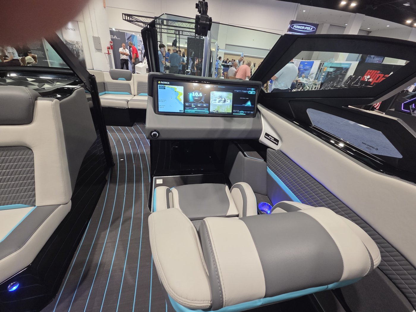 Patrick wake boat cockpit with gray seats, teal-lit deck and wide helm screen