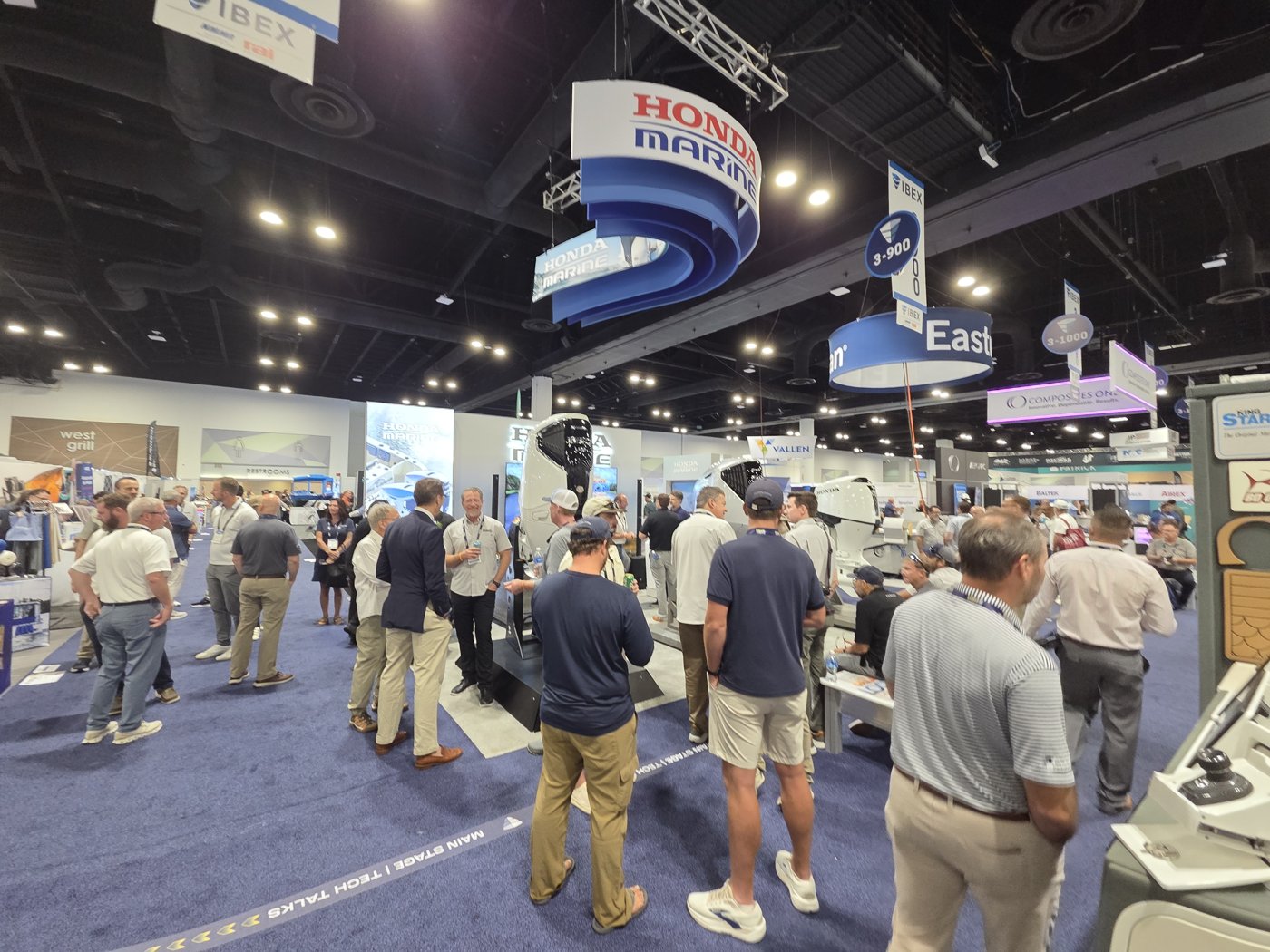 Crowd at the Honda Marine booth 3-900 under the hanging Honda Marine sign