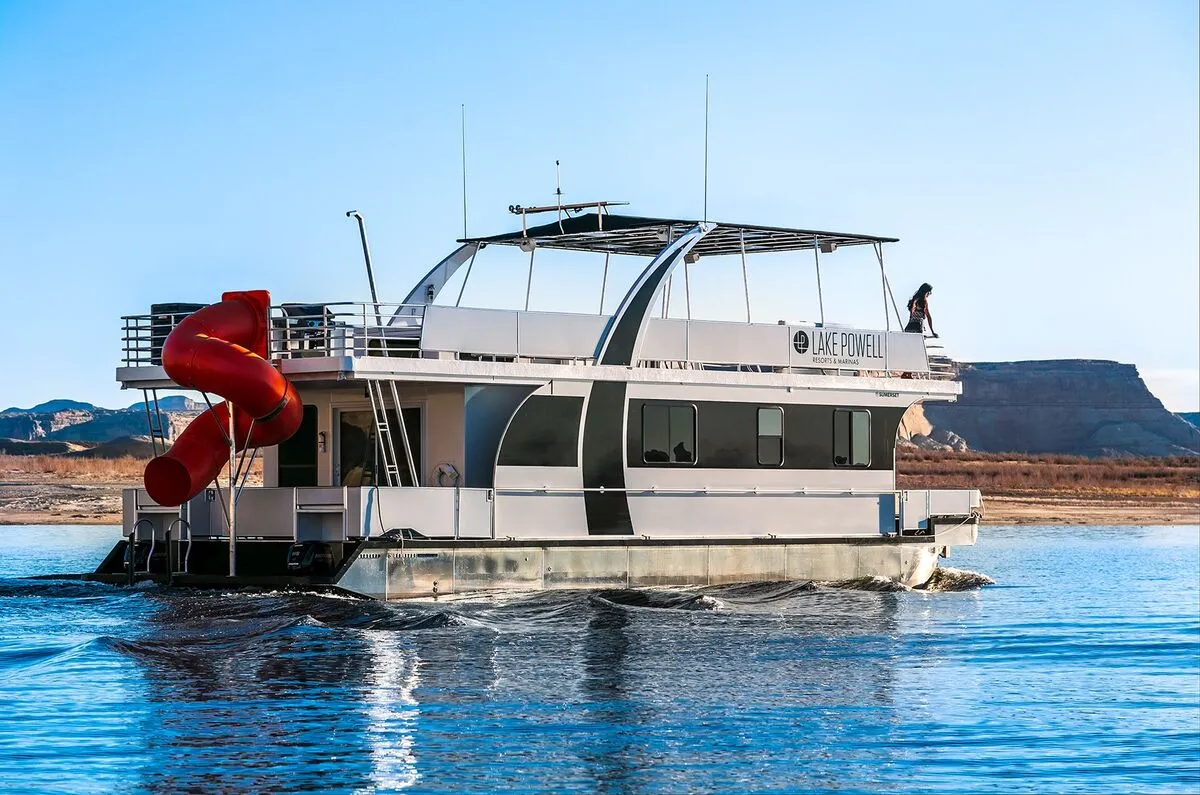Houseboats in a red sandstone canyon at Lake Powell Utah Arizona border