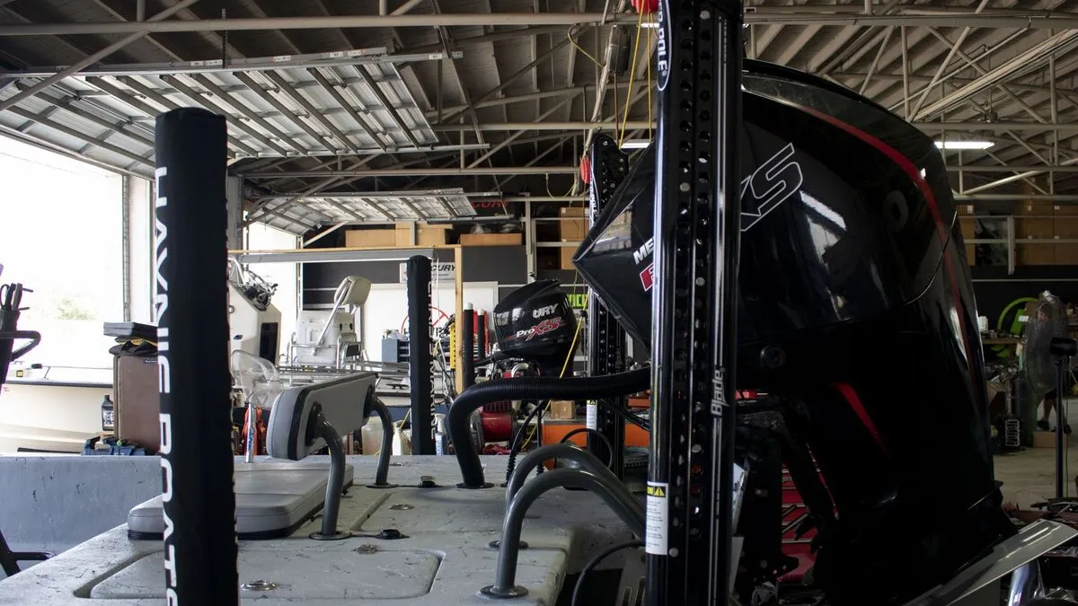 Marine repair shop with outboard motors and parts on shelves