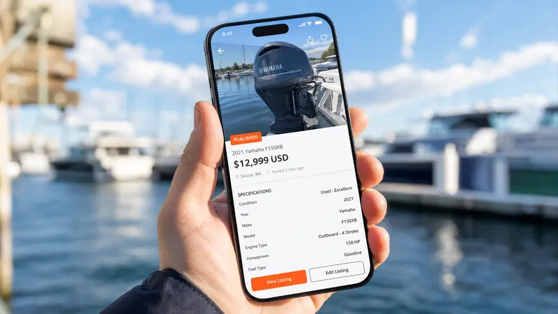 Hand holding smartphone showing a published engine listing with LIVE badge at marina